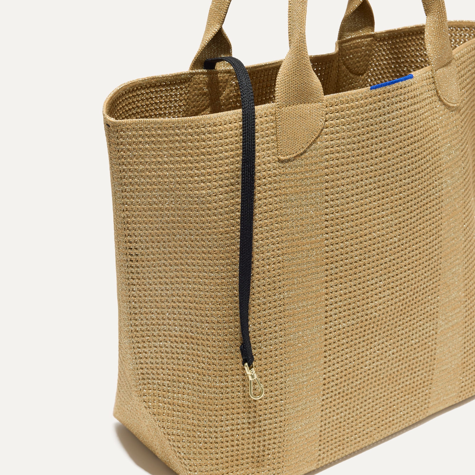 The Lightweight Tote in Golden Perf shown with its handy key leash.