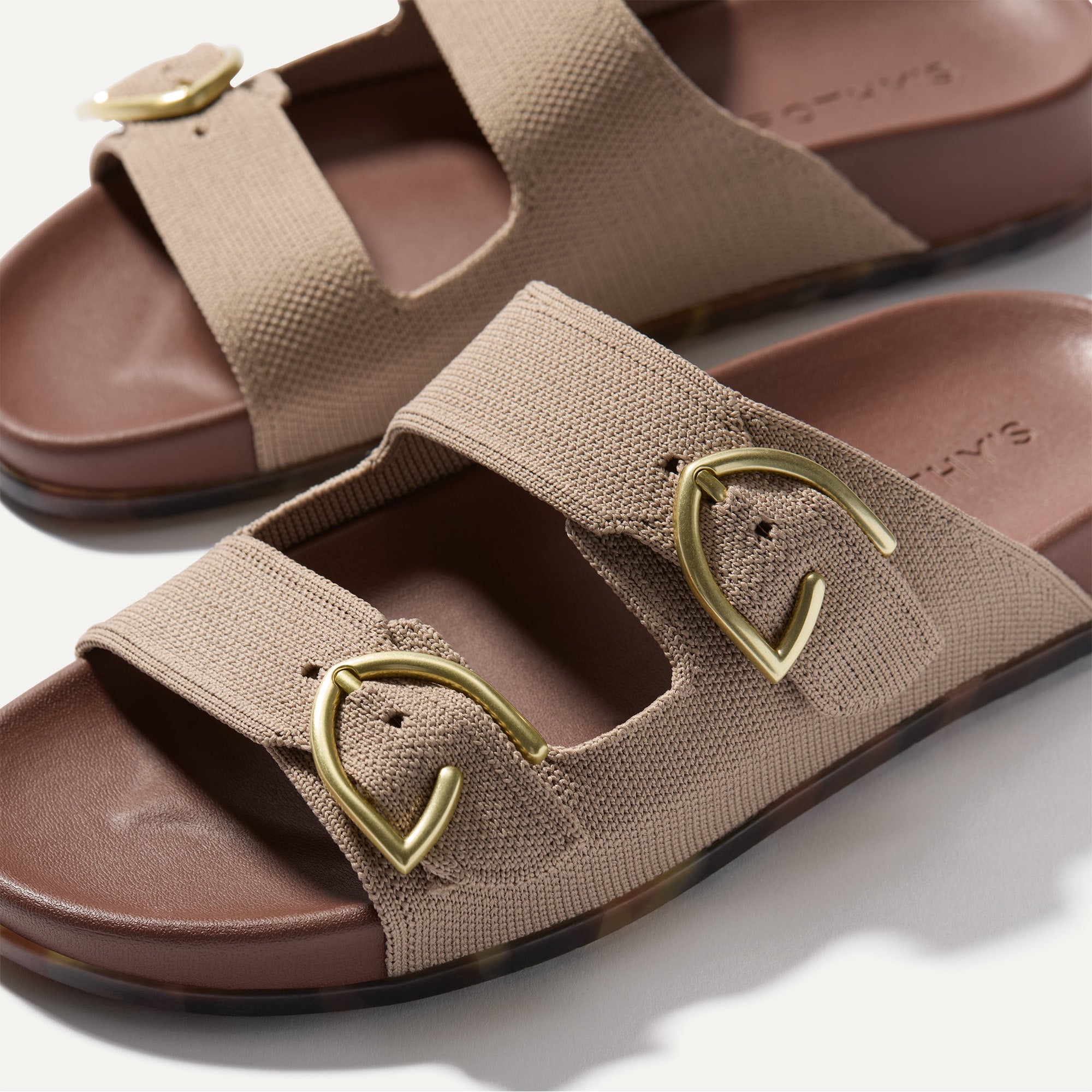 Close up of buckle closer of The Buckle Slide Sandal in Dune.