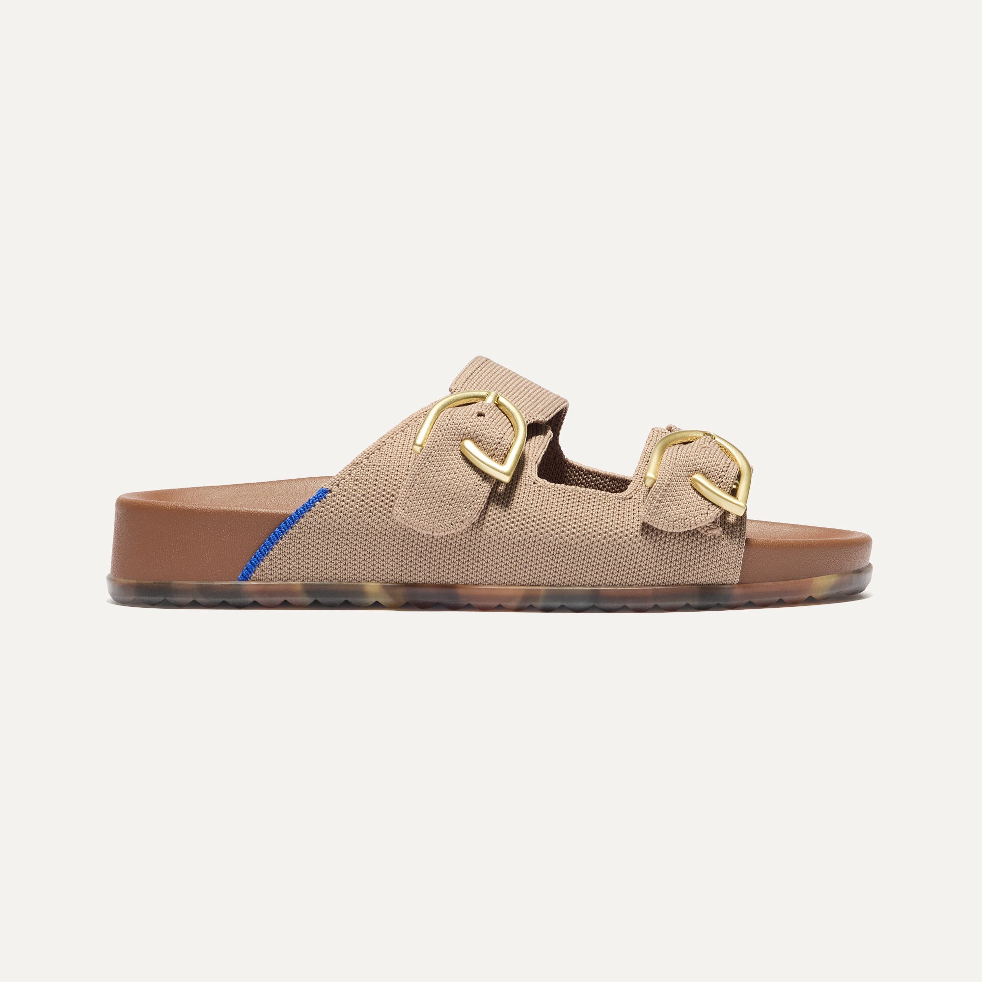 The Buckle Slide Sandal in Dune shown from the side.